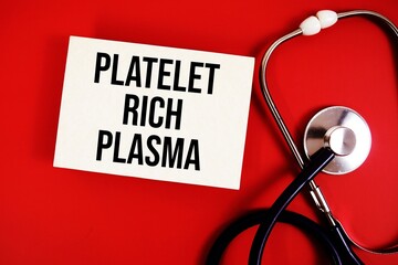 Platelet Rich Plasma text written on paper card with stethoscope on red background