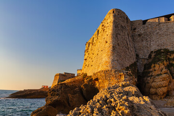Majestic stone walls of Ulcinj Fortress at sunset over rocky coast, Montenegro
