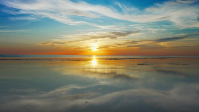 Golden sunlight shimmers across a gently rippling water surface, captured from a grounded perspective&mdash;soft cloud reflections blend with subtle wave patterns, evoking tranquil rhythm and the dynamic ca