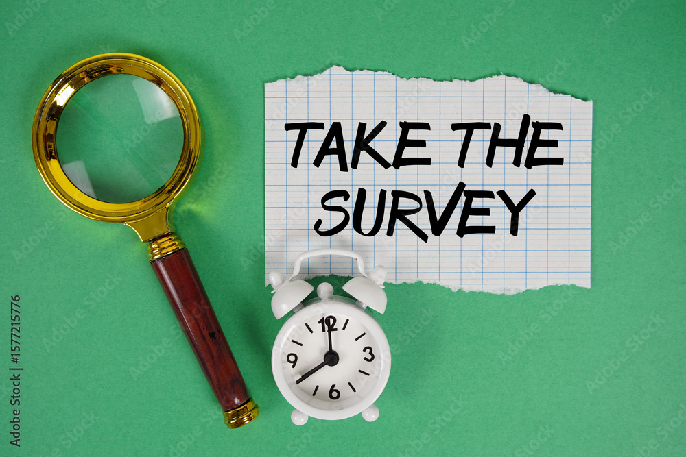 Fototapete take the survey text written on paper with magnifying glass and alarm clock