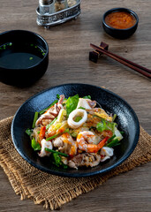 fried  sukiyaki pork and seafood with vegetable and sukiyaki sauce, Thai street food