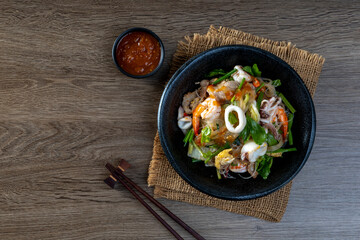 fried  sukiyaki pork and seafood with vegetable and sukiyaki sauce, Thai street food