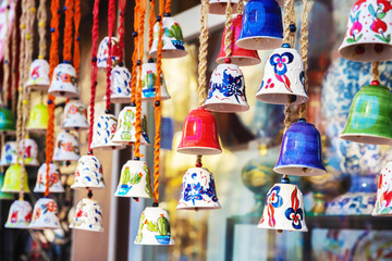 Colorful traditional Iznik ceramic bells as souvenirs displayed in market shop in Bursa, Turkey