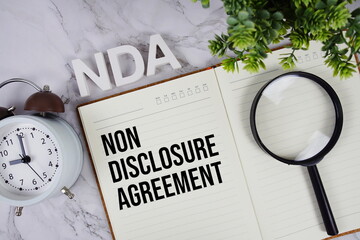 NDA - Non Disclosure Agreement acronym on notepad, Business concept background