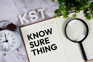 KST - Know Sure Thing acronym on notepad, Business concept background