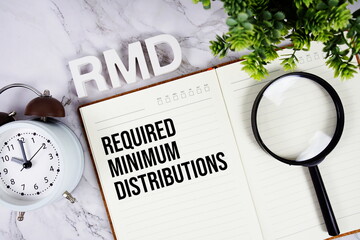 RMD - Required Minimum Distributions acronym on notepad, Business concept background