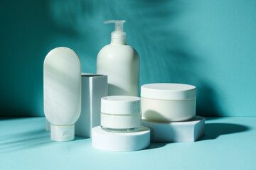 Cosmetic products at podium on blue background.