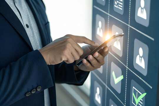 Businessman using smartphone interacting with digital interface displaying user icons and checkmarks