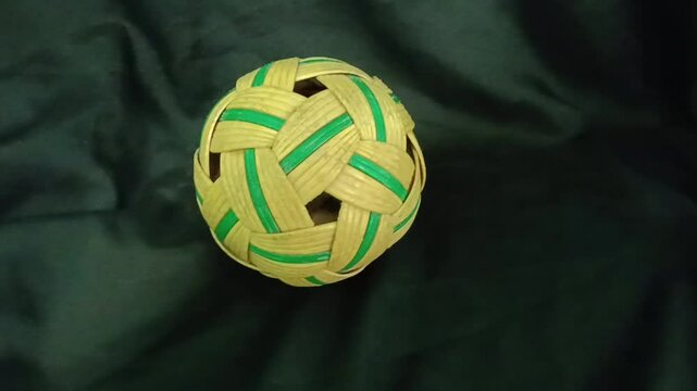 synthetic rattan sepaktakraw or takraw or  buka ball, kick volleyball or foot volleyballball on black background , closeup of photo taken in malaysia.
