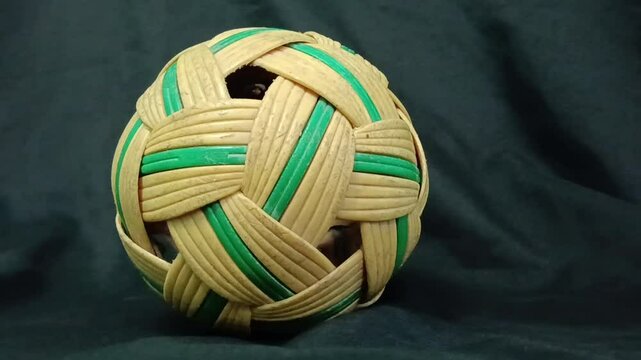 synthetic rattan sepaktakraw or takraw or  buka ball, kick volleyball or foot volleyballball on black background , closeup of photo taken in malaysia.