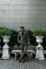 man in classic suit in the garden on the street