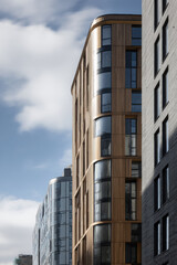 Fototapeta premium modern wooden facades of buildings showcase intricate designs and textures that highlight harmony of nature and