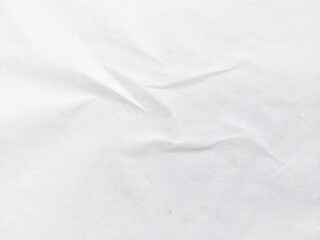 Wrinkled white paper texture background with wavy surface. Crumpled white vintage paper surface texture for background. Crumpled paper, abstract background. Paper background with copy space for text.