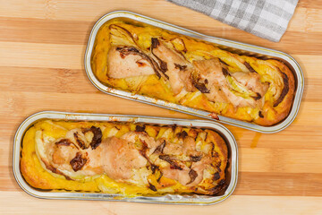 Potato casserole with chicken meat in foil containers, top view