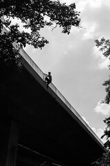 Black and white photo of a man performing a parkour trick. Extreme sports photo.