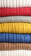 Stack of colorful knitted sweaters