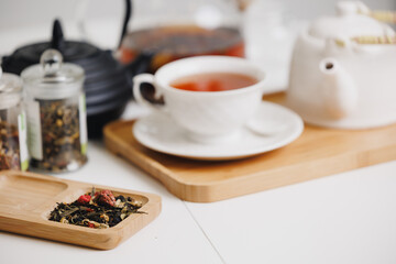 Elegant Herbal tea arrangement with porcelain teapot, teacup, and loose leaf blends