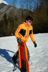 Teen Carrying Sledge in Snowy Mountain Setting