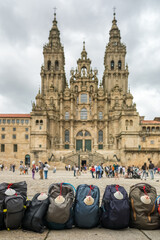Backpacks with traditional Pilgrims shells at the foot of the Cathedral of Santiago de Compostela,...