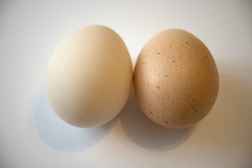 Two brown chicken eggs isolated on white background