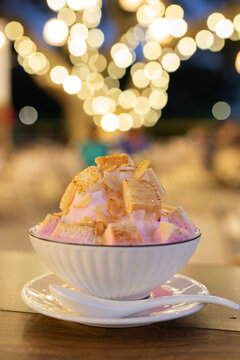 Volcano Bingsu- Pink shaved ice bingsu topped with a rich sauce and toasted bread and almonds.
