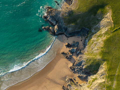 Beautiful aerial drone landscape image of Holywell Bay in Cornwall during colorful vibrant Summer sunset