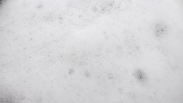 Soft and light white soap foam texture. Countless tiny bubbles create an attractive and soothing abstract pattern.