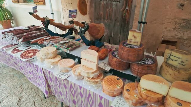 Food stall with dairy and meat products at Majorca farmers market Spain