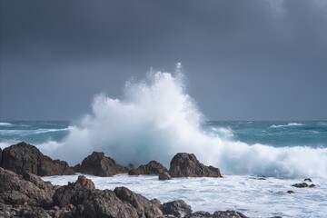 Obraz premium Roaring ocean waves crash onto jagged rocks, evoking tempestuous seas and invoking the spirit of World Oceans Day