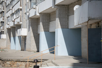 large brick blue plastered concrete arches on the ground floor of an apartment building