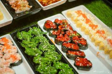 Various sushi toppings on trays ready for sale