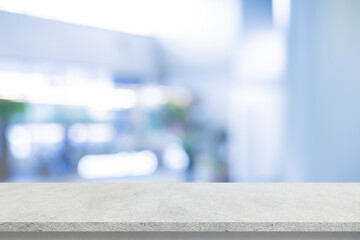 abstract blurred interior of entrance of hospital background with concrete texture tabletop for show and promote content or product on display