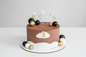 Chocolate birthday cake with gold stars and number one