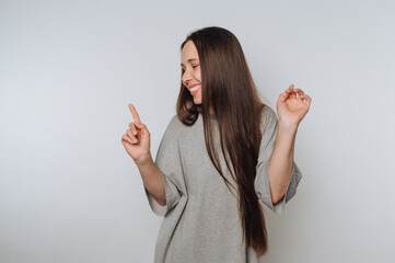 joyful woman dances with her finger raised, radiating happiness and playfulness on white background