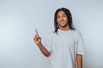 young man raises one finger with a focused expression, suggesting the presence of an idea or realization that sparks curiosity on white background