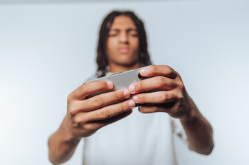 teenager intensely focused on his smartphone, highlighting the world of mobile gaming on white...