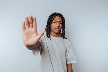 teenager presents a stopping gesture, expressing seriousness and authority in a minimalistic...