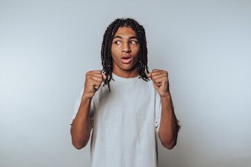 young man displays a fighting stance with a look of surprise, highlighting reaction and readiness...