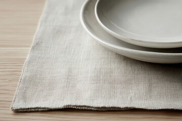 Linen placemat with ceramic plates on wooden table