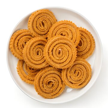 
Golden Murukku: A Delicious Indian Snack in a white plate top down view