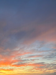 Beautiful photo of a tranquil sunset sky with pastel shades of orange, pink, blue, and purple clouds. 