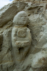 Carved Stone Figure with Heart Design
