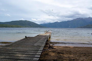Serene Lake View with Wooden Pier and Mountains