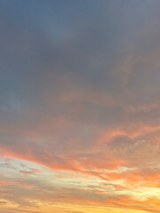 Obraz premium s A minimalist photograph of a sunset sky painted in soft pastel hues of orange, pink, and blue.