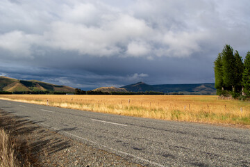Scenic Rural Landscape with Gravel Road and Mountains