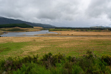 Serene Landscape with River and Mountains