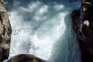 Rushing Water Flowing Between Rocks