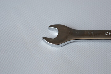 metal wrench with size marking 13 on a white background, ideal for themes like repair, mechanics,...