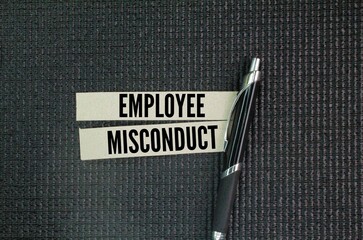 Pen and paper with the word employee misconduct. the concept of employee misconduct or employee...