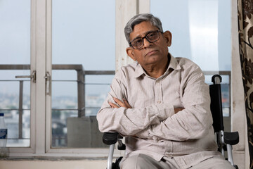 Portrait Indian disabled senior old man in chair. Depressed retired lonely old man frustrated elder man hands on walking stick, sitting on wheelchair alone, loneliness, Care